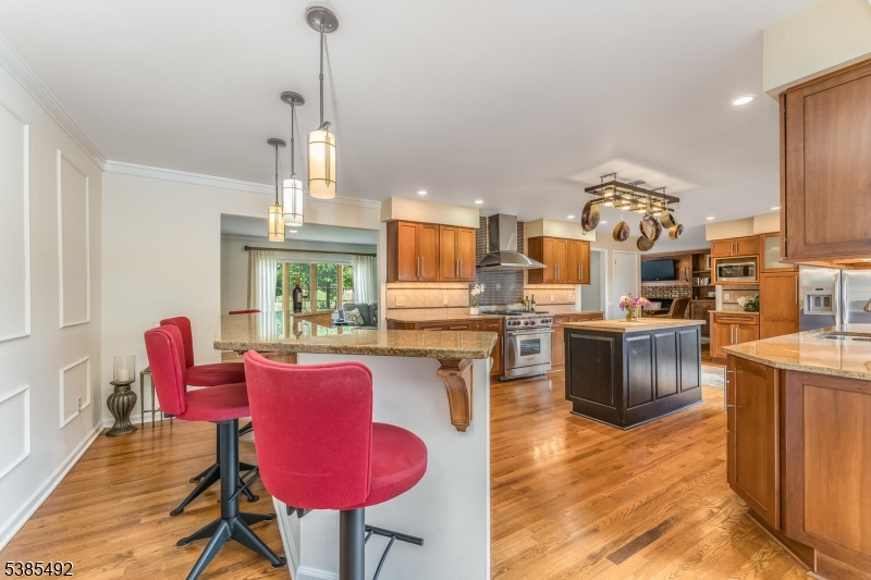 48 West Main Street Mendham, NJ 07945 - Photo 10 of 28 a kitchen with stainless steel appliances granite countertop a stove kitchen island a dining table and chairs