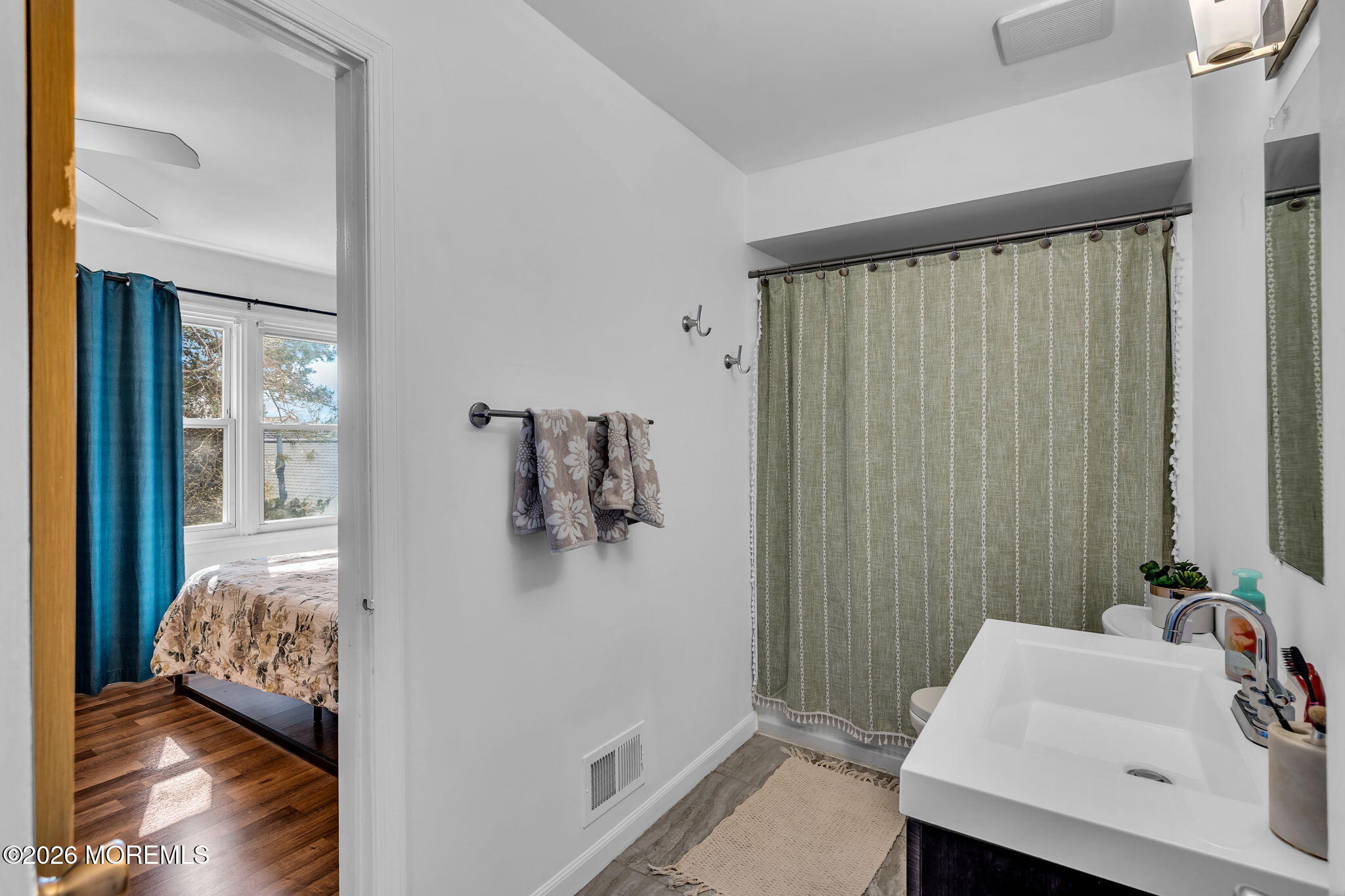 39 Independence Court Jackson, NJ 08527 - Photo 17 of 24 a bedroom with a bed and a table in it
