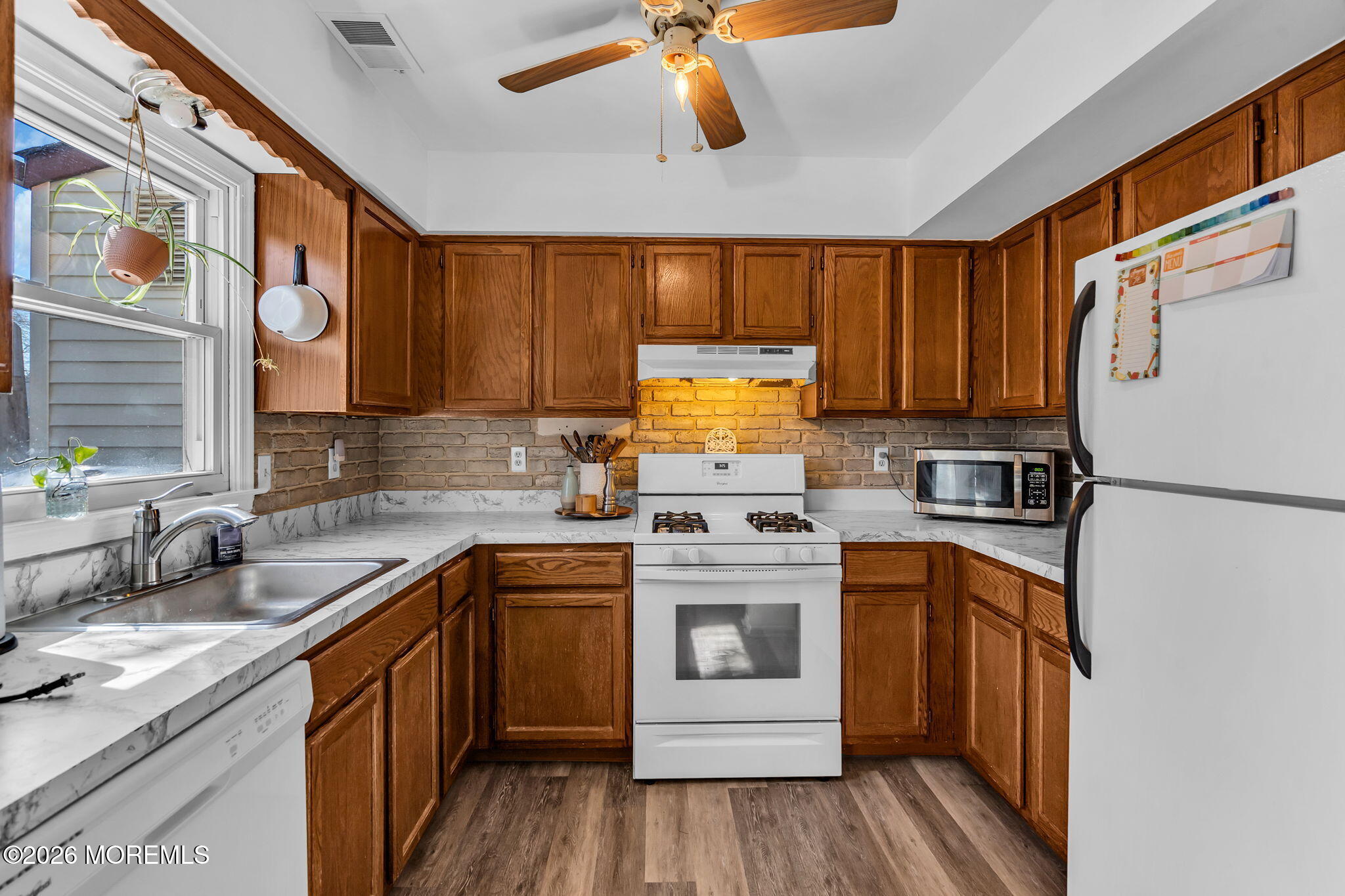 39 Independence Court Jackson, NJ 08527 - Photo 9 of 24 a kitchen with stainless steel appliances granite countertop a sink a stove a refrigerator cabinets and wooden floor