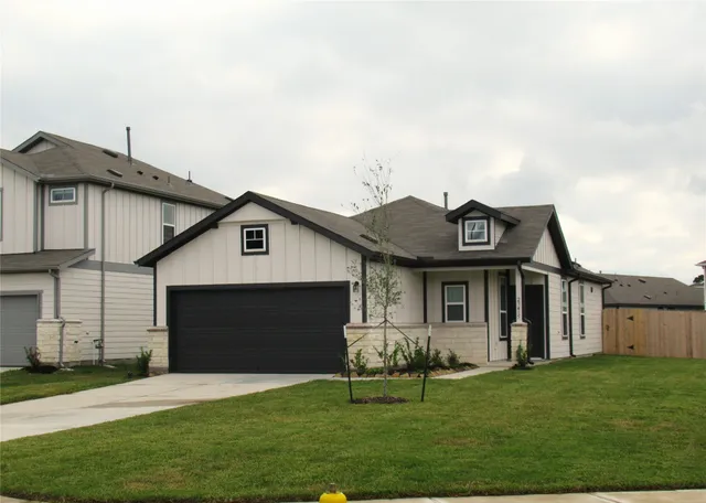 a front view of a house with a garden and yard