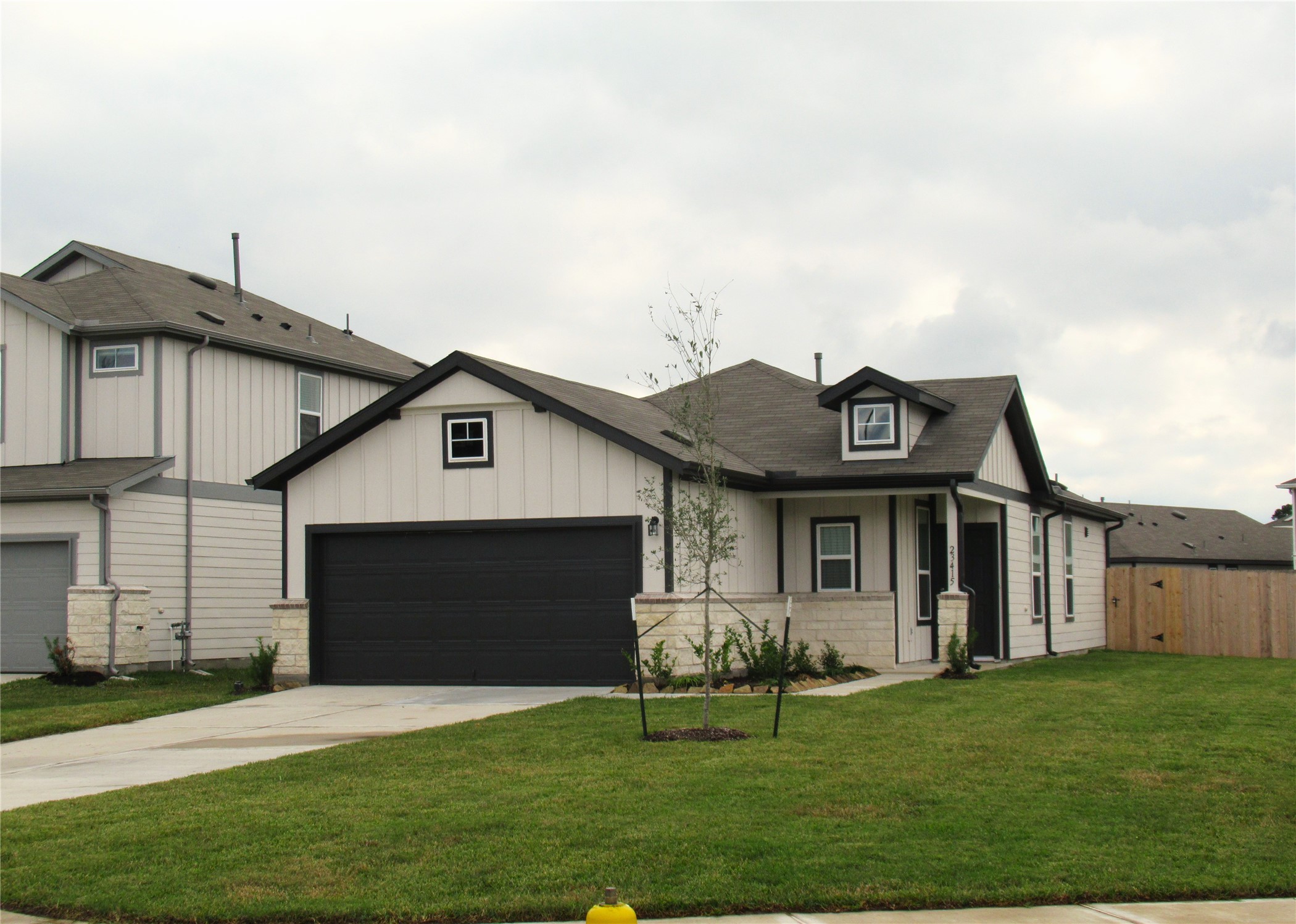 23415 Pinetum Cir Spring Spring, TX 77373 - Photo 3 of 17 a front view of a house with a garden and yard