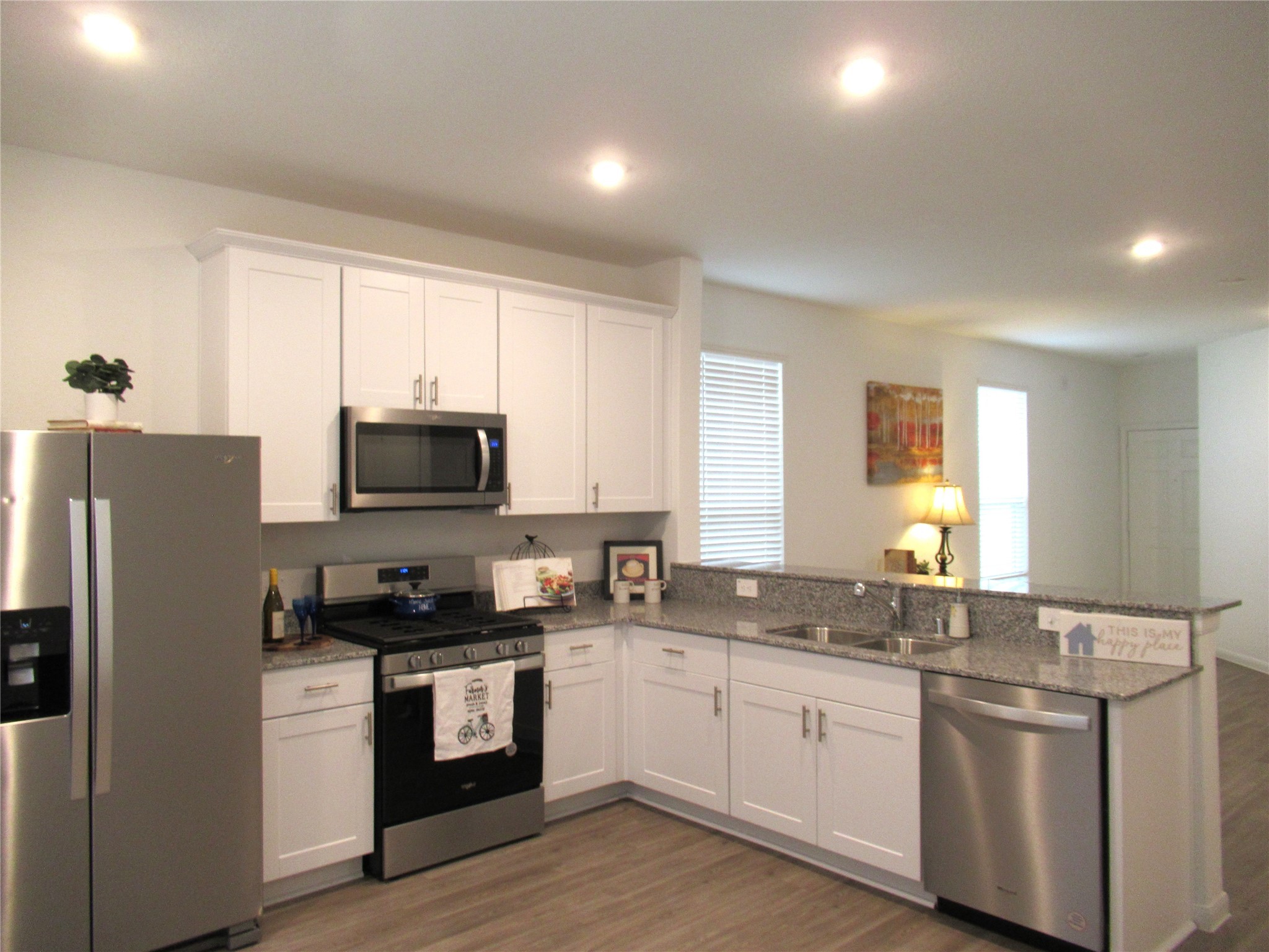 23415 Pinetum Cir Spring Spring, TX 77373 - Photo 6 of 17 a kitchen with granite countertop white cabinets and stainless steel appliances