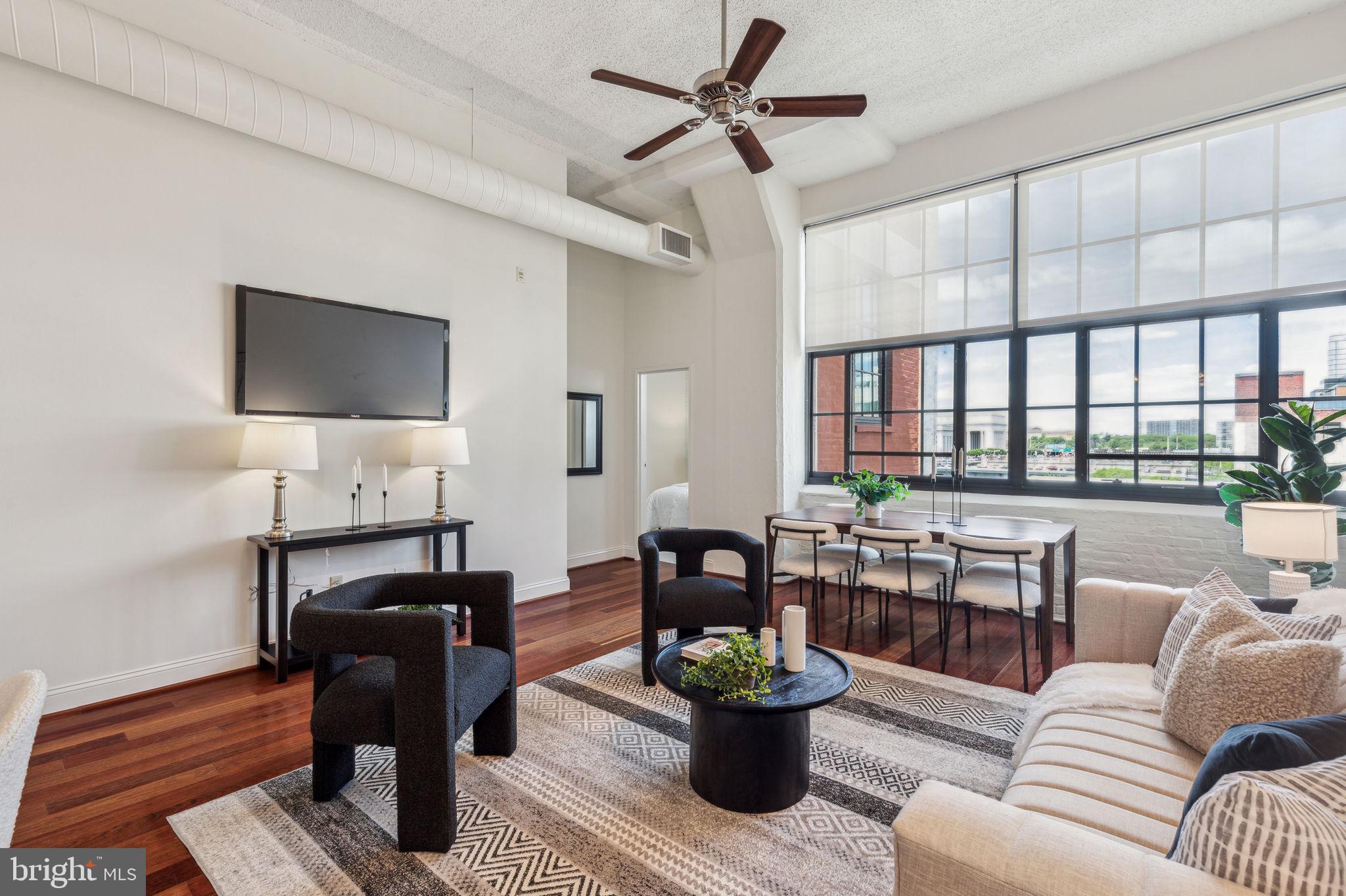 2429 Locust Street, Unit 504 Philadelphia, PA 19103 - Photo 1 of 7 a living room with furniture and a flat screen tv
