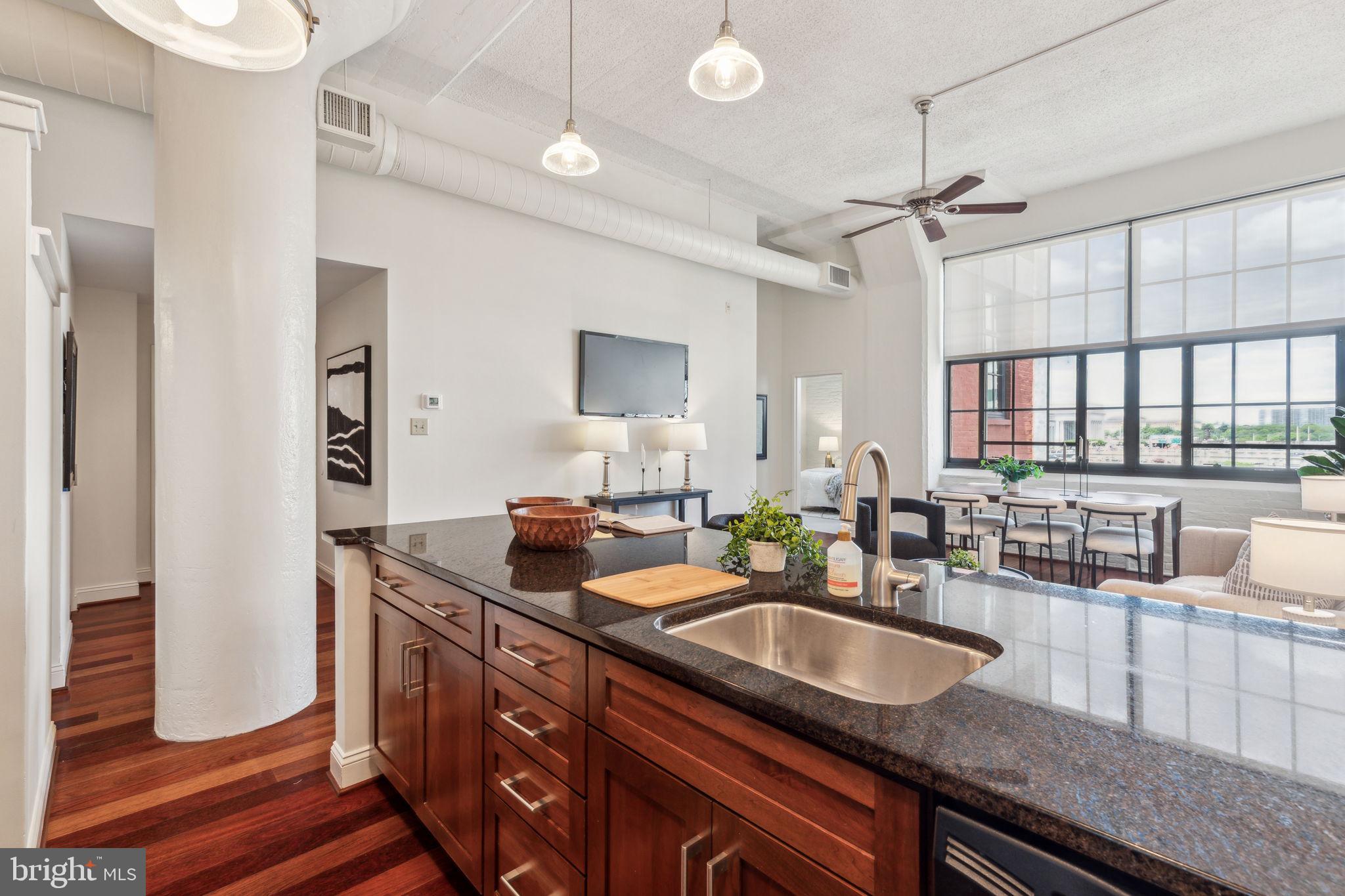 2429 Locust Street, Unit 504 Philadelphia, PA 19103 - Photo 3 of 7 a kitchen with granite countertop a sink a counter space and windows