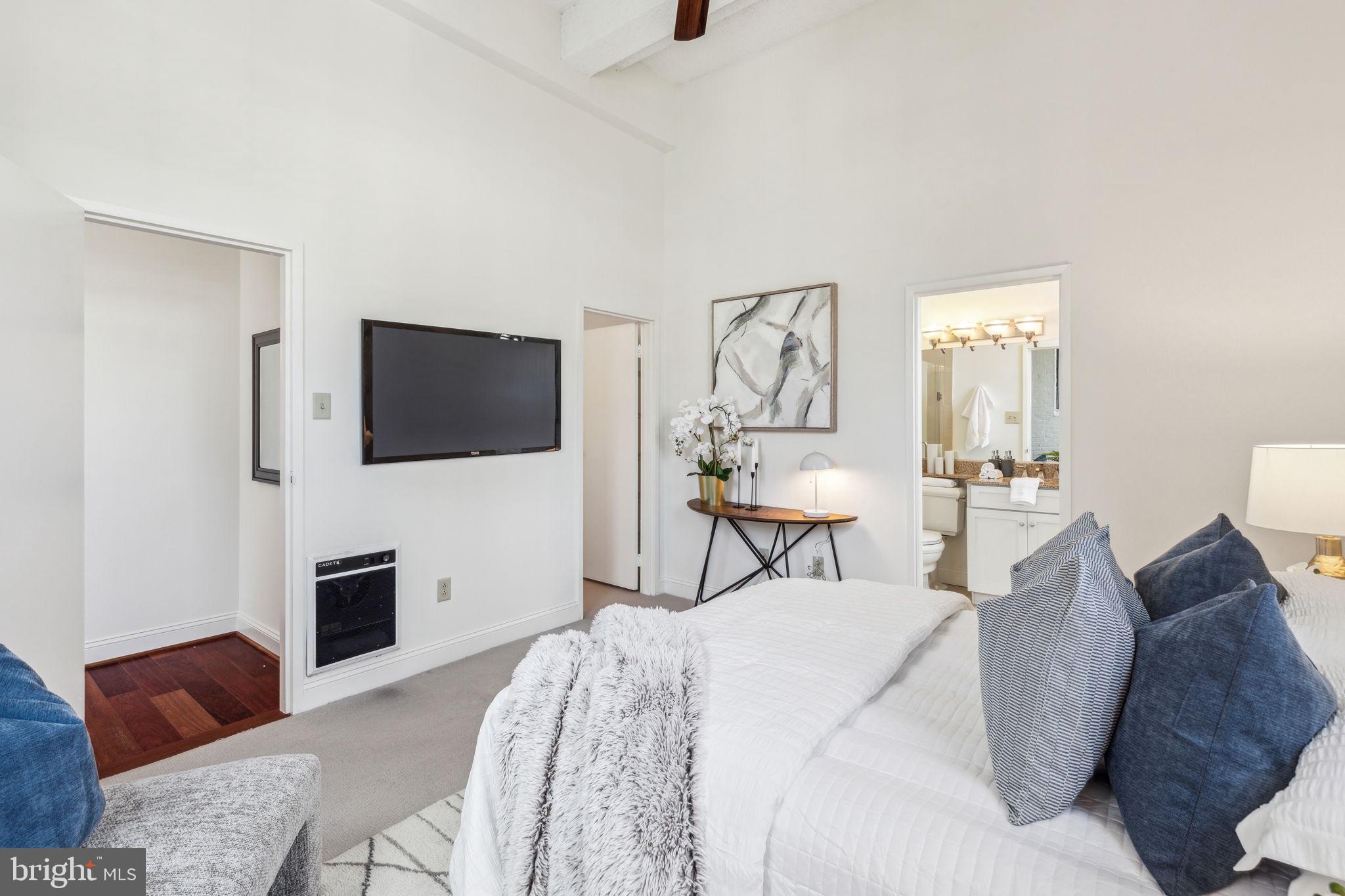 2429 Locust Street, Unit 504 Philadelphia, PA 19103 - Photo 4 of 7 a bedroom with a bed and a flat screen tv