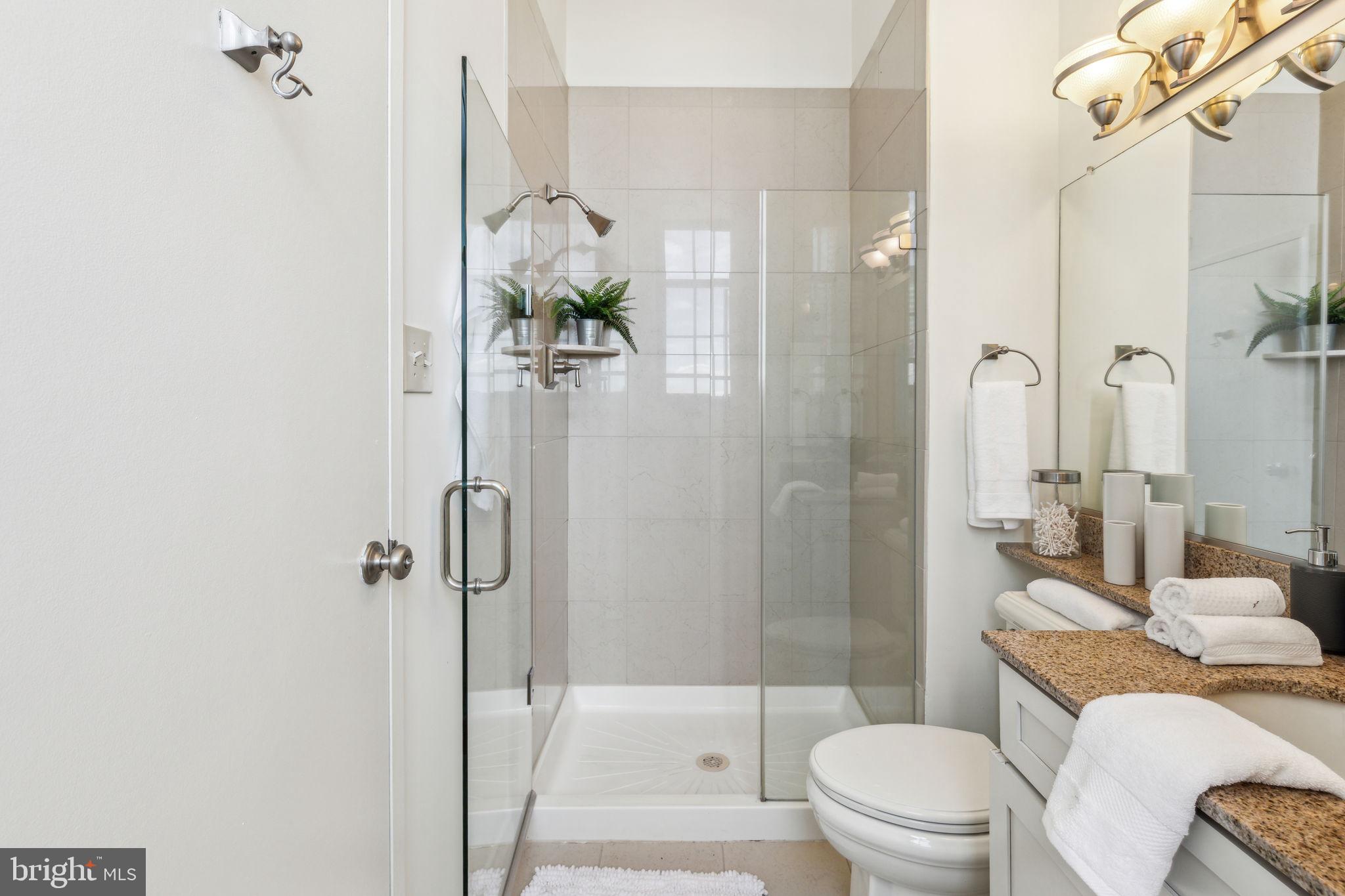 2429 Locust Street, Unit 504 Philadelphia, PA 19103 - Photo 5 of 7 a bathroom with a shower a toilet and a sink