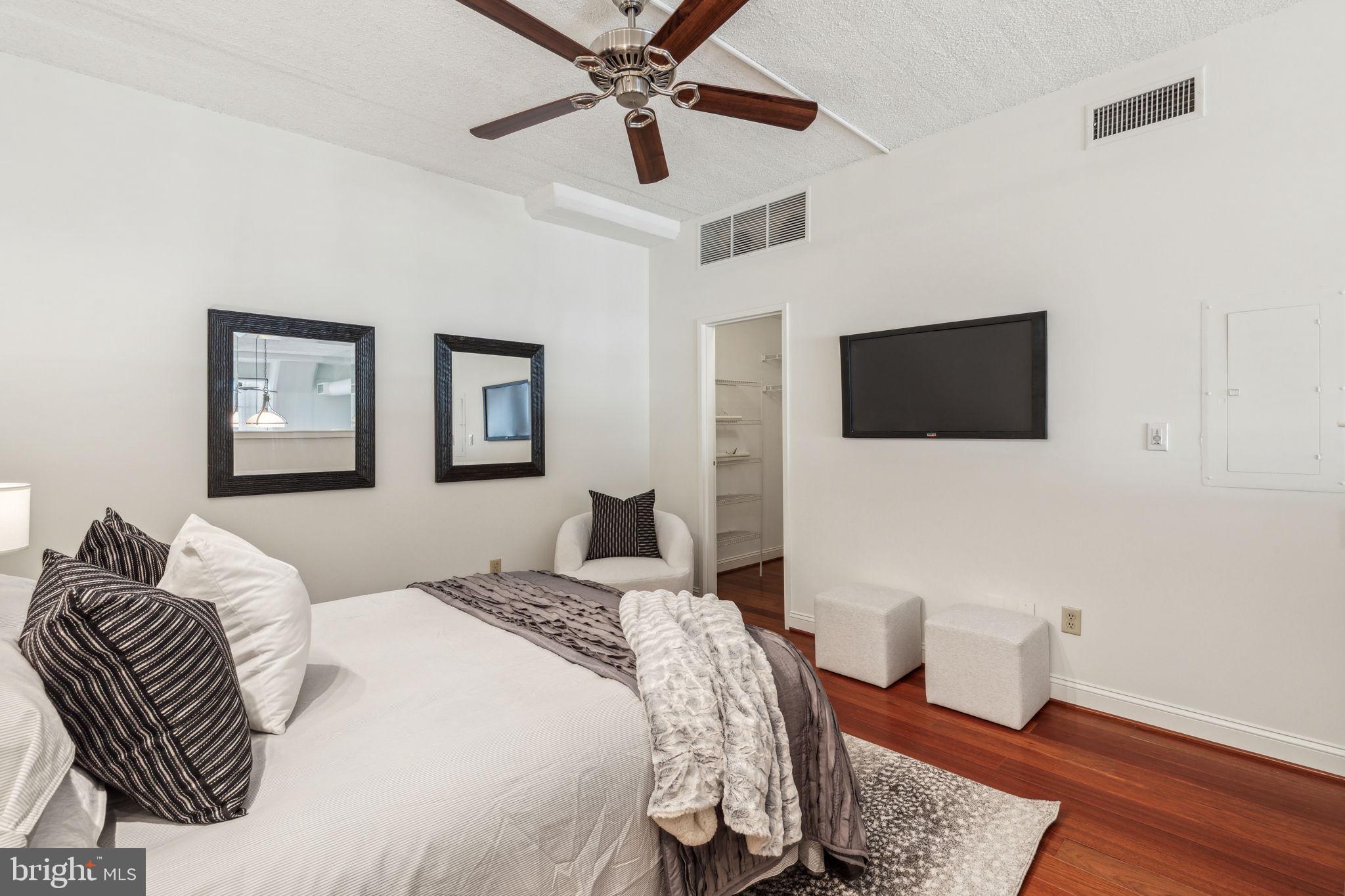 2429 Locust Street, Unit 504 Philadelphia, PA 19103 - Photo 6 of 7 a bedroom with a bed and a flat screen tv