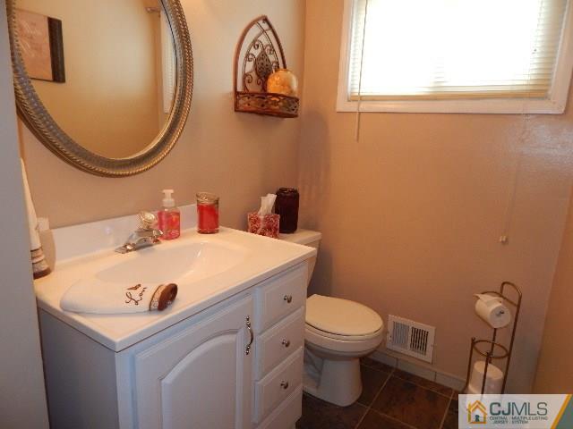 3042 Cheesequake Road Old Bridge, NJ 08859 - Photo 14 of 22 a bathroom with a sink mirror and toilet