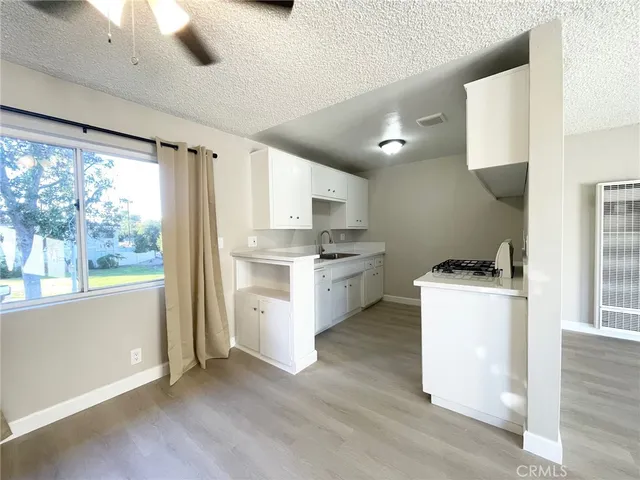 a kitchen with a stove a sink and a refrigerator