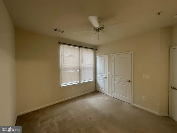 an empty room with a empty space and windows