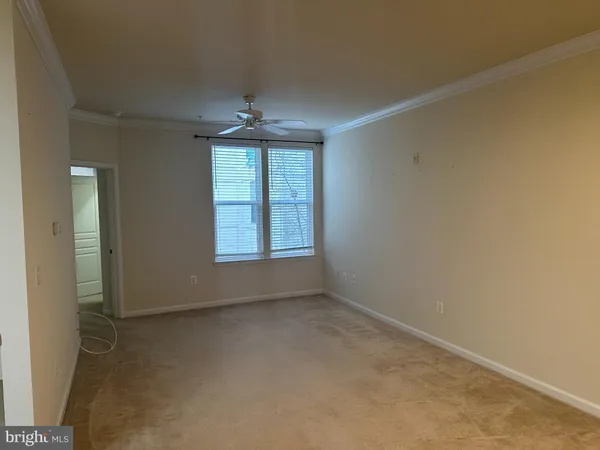 an empty room with windows and chandelier