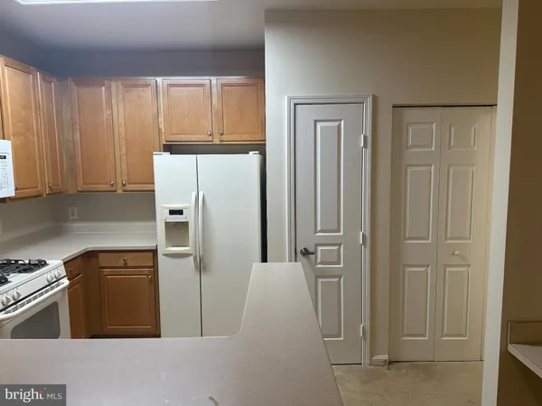 a kitchen with cabinets and stainless steel appliances