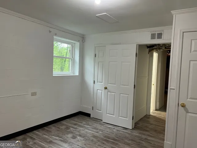 a view of a hallway with wooden floor