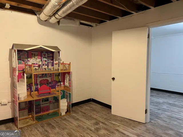 a view of hallway with wooden floor