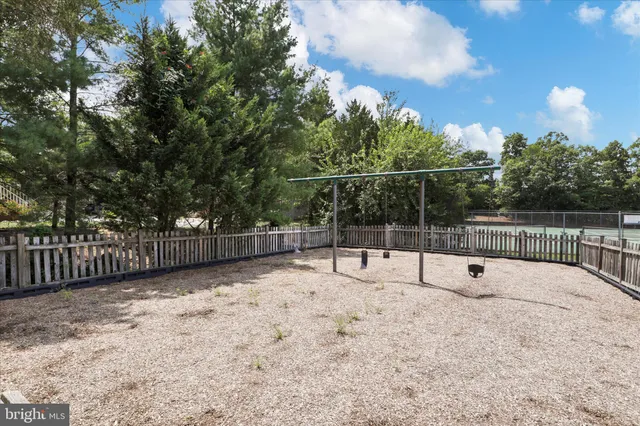 a view of a backyard with wooden fence