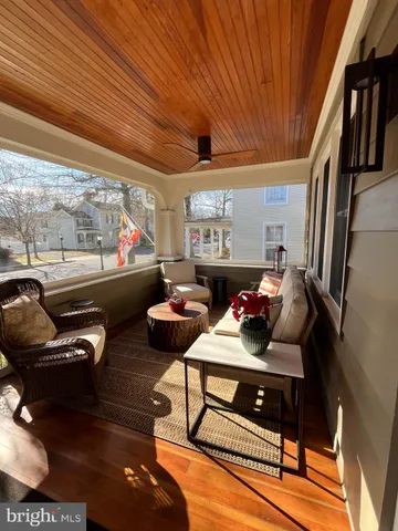 a dining room with wooden floor and large window