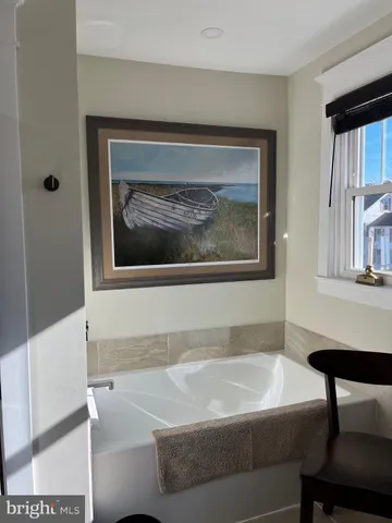 a view of a dinning table and chairs in patio of the house
