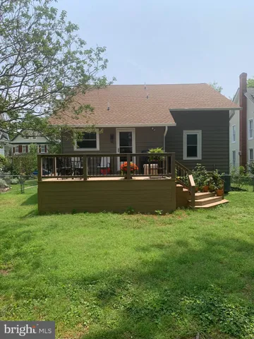 a spacious bathroom with a granite countertop sink a mirror and a bathtub