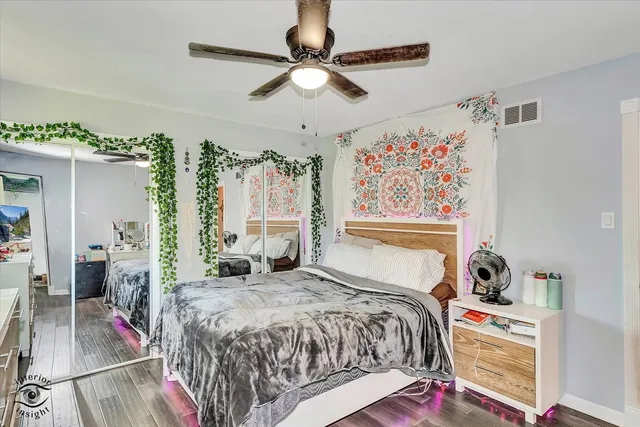 a bed room with a bed and a painting on the wall