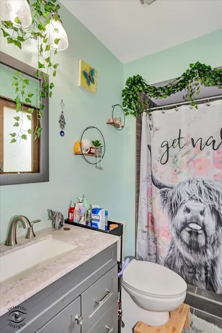 a bathroom with a sink mirror and toilet