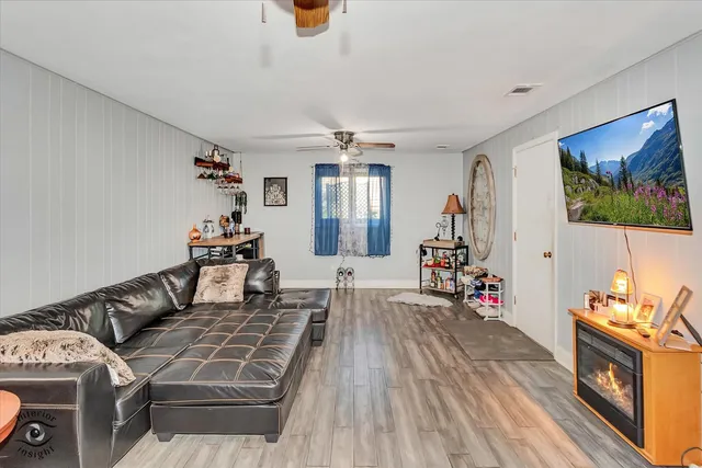 a living room with furniture and wooden floor
