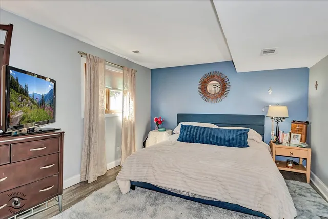 a bedroom with a bed and a flat screen tv