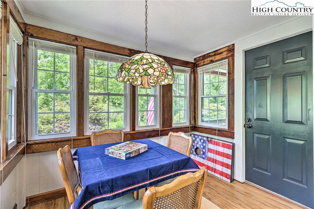 2280 Garvey Bridge Road Crumpler, NC 28617 - Photo 20 of 40 a view of a dining room with furniture a chandelier and wooden floor