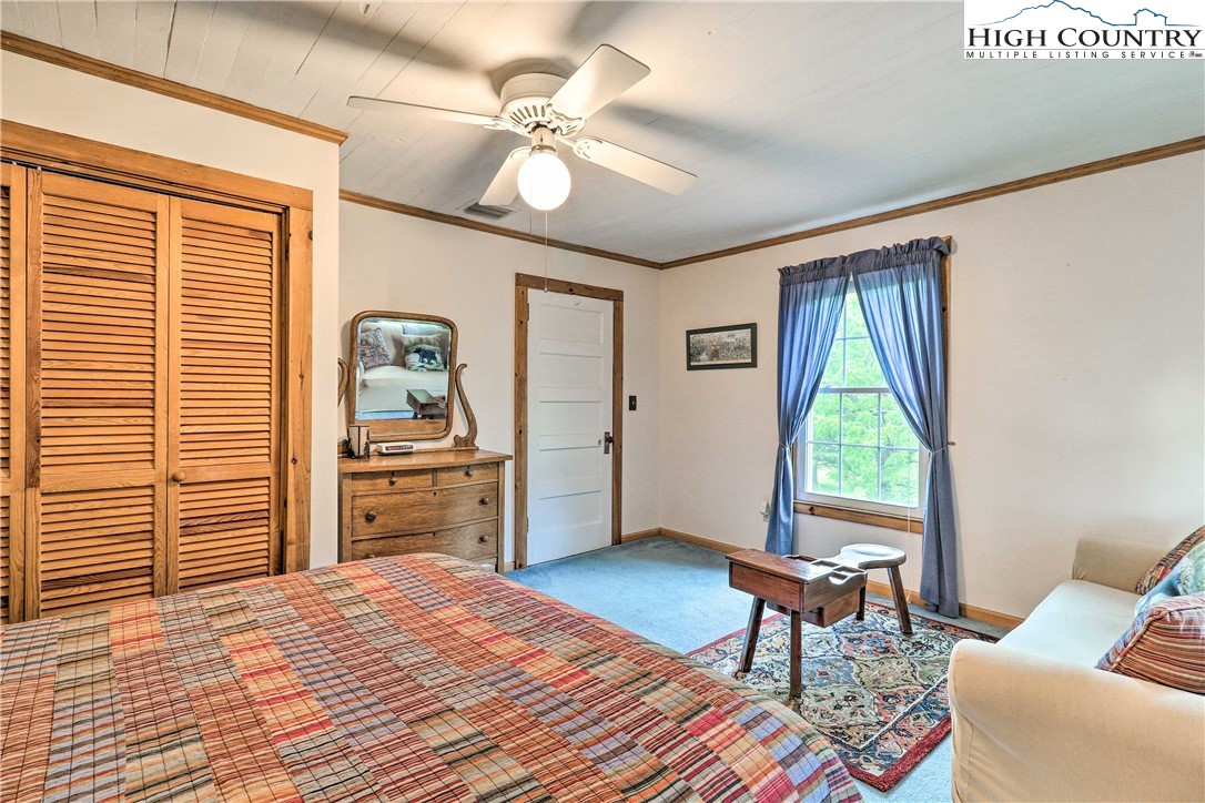 2280 Garvey Bridge Road Crumpler, NC 28617 - Photo 22 of 40 a bedroom with furniture and a window