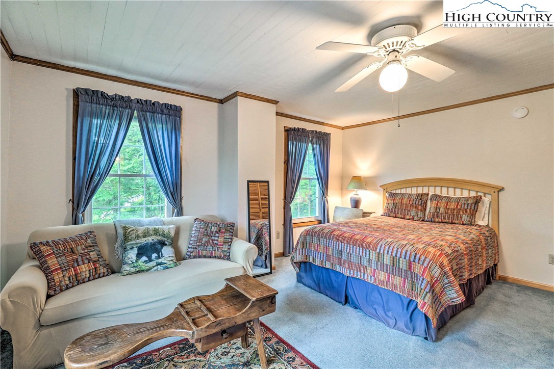 2280 Garvey Bridge Road Crumpler, NC 28617 - Photo 23 of 40 a bedroom with a large bed and a couch