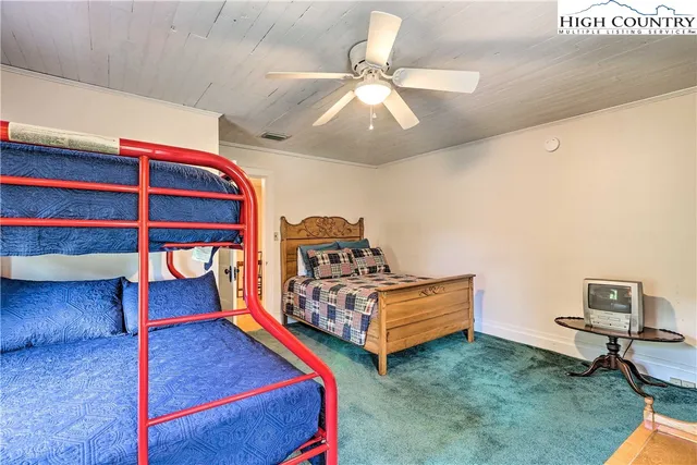 a bedroom with two beds and painted walls