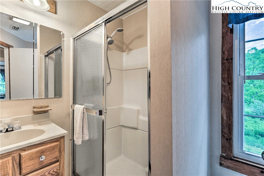 2280 Garvey Bridge Road Crumpler, NC 28617 - Photo 27 of 40 a bathroom with a sink and a mirror