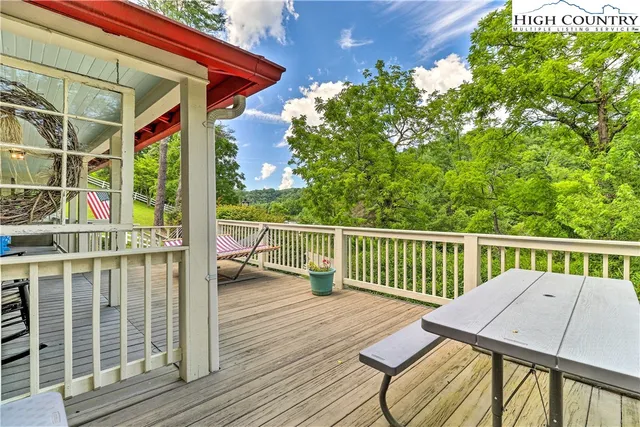 a view of a deck with two chair and wooden floor
