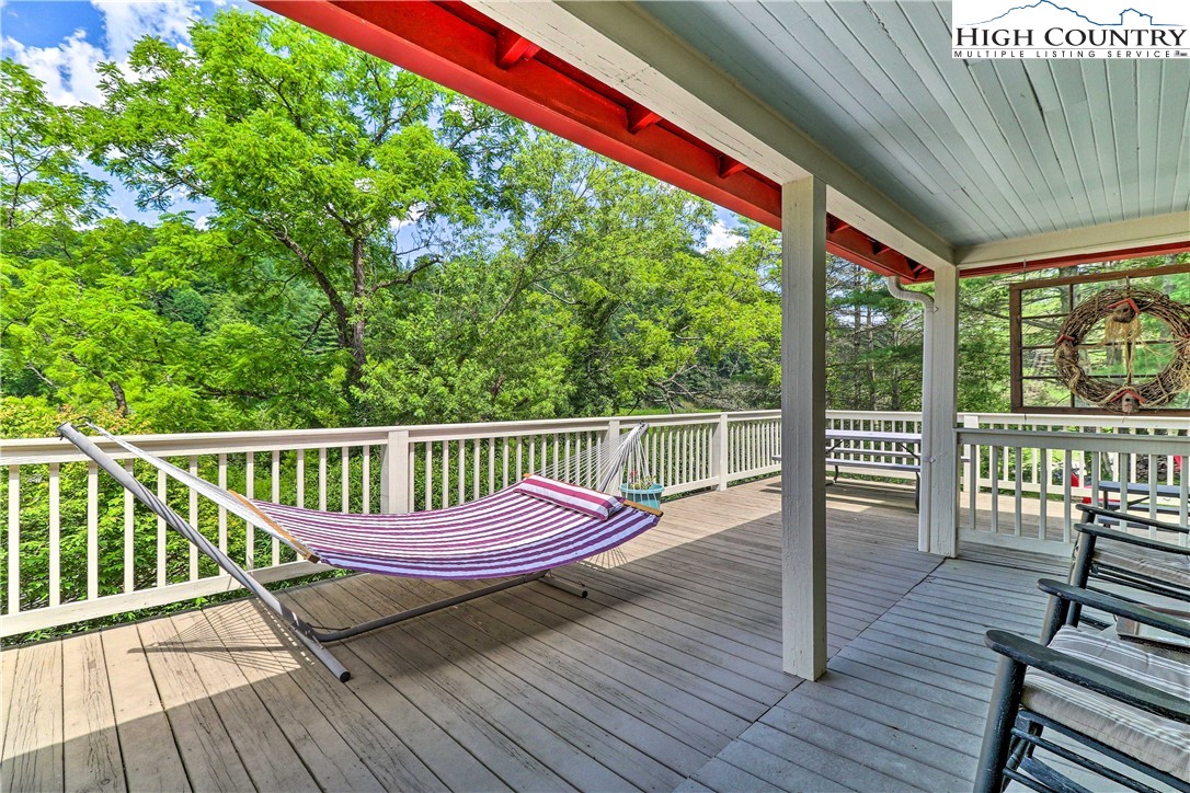 2280 Garvey Bridge Road Crumpler, NC 28617 - Photo 30 of 40 a view of a wooden deck with a bench