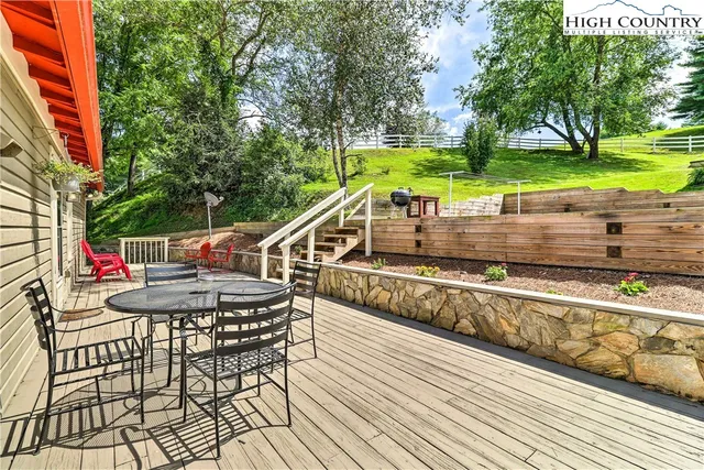 a view of a chair and tables on the deck