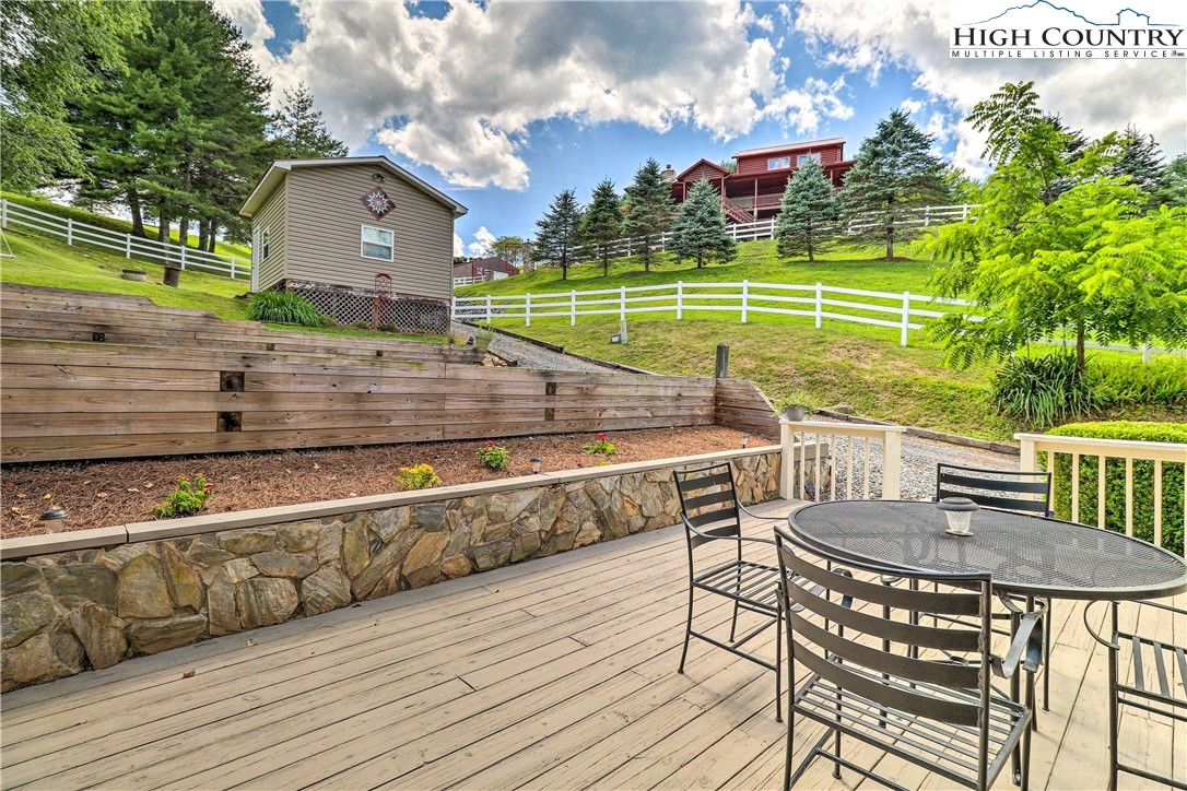 2280 Garvey Bridge Road Crumpler, NC 28617 - Photo 32 of 40 a view of a chairs and table on the wooden floor