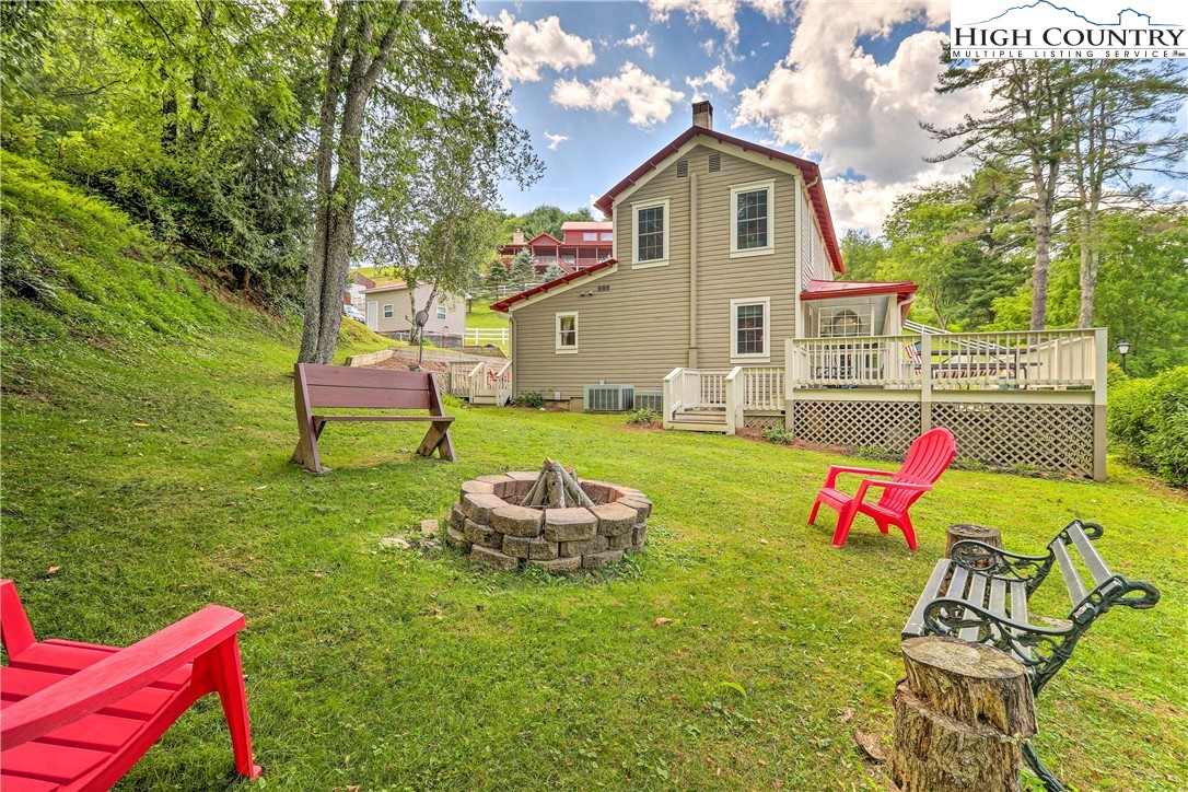 2280 Garvey Bridge Road Crumpler, NC 28617 - Photo 35 of 40 a front view of a house with a yard table and chairs