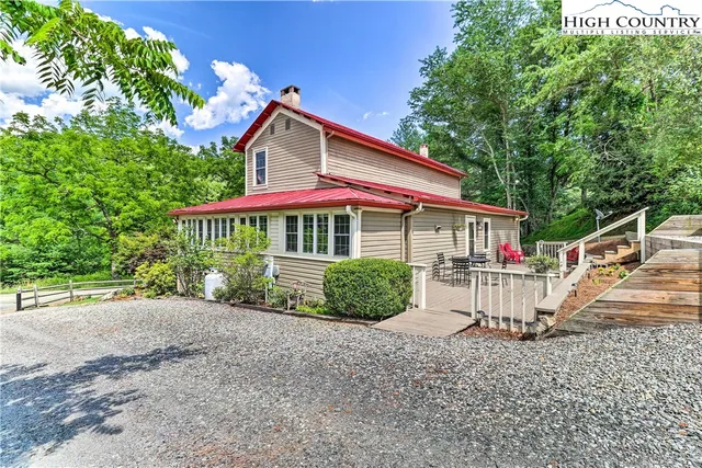a view of house with outdoor space and trees