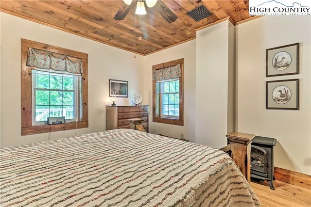 a bedroom with a large bed and a window