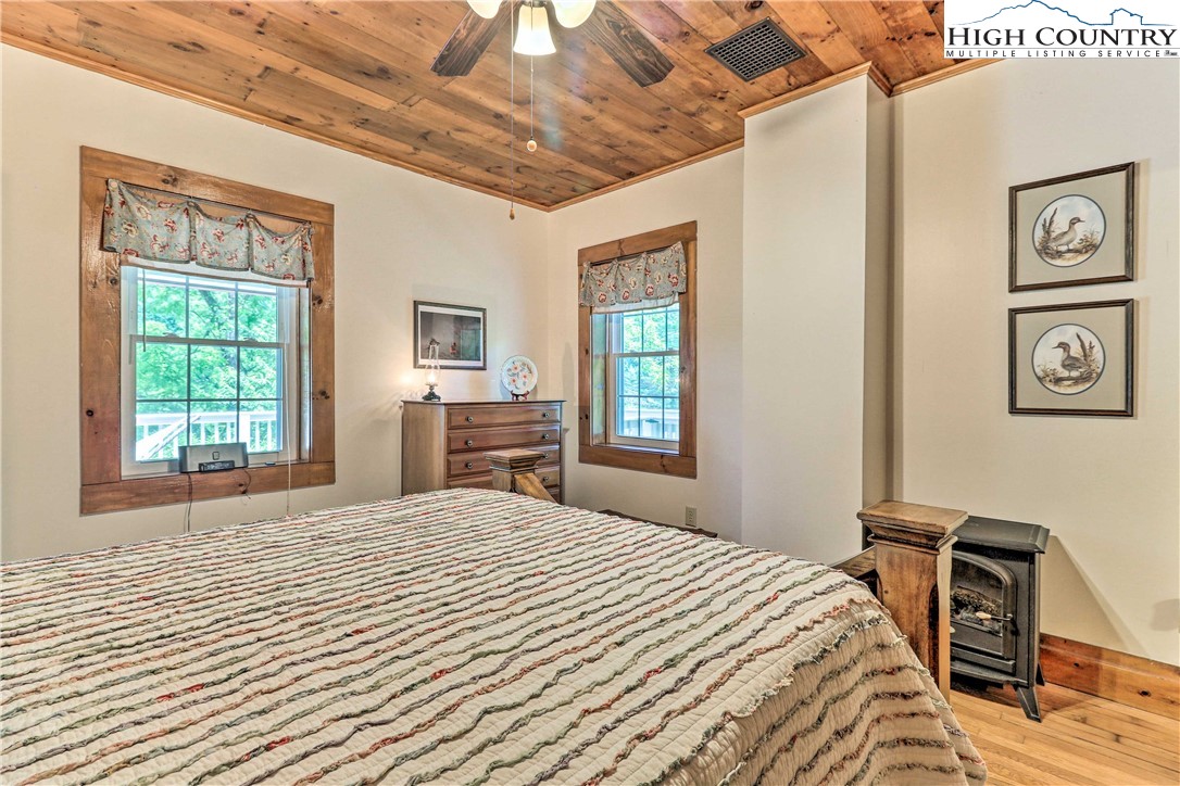 2280 Garvey Bridge Road Crumpler, NC 28617 - Photo 8 of 40 a bedroom with a large bed and a window