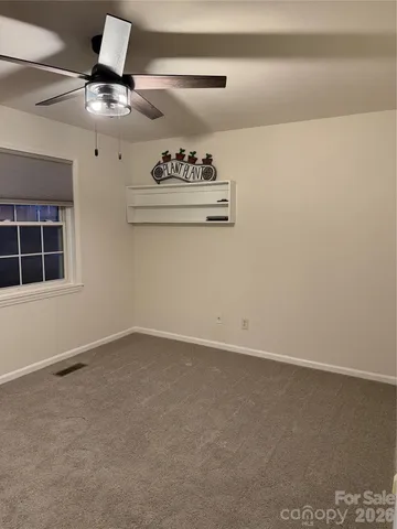 a view of empty room with windows