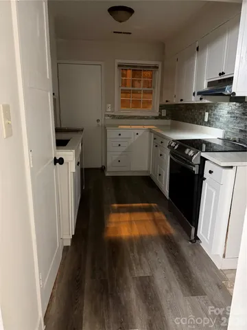 a kitchen with wooden cabinets and a stove top oven