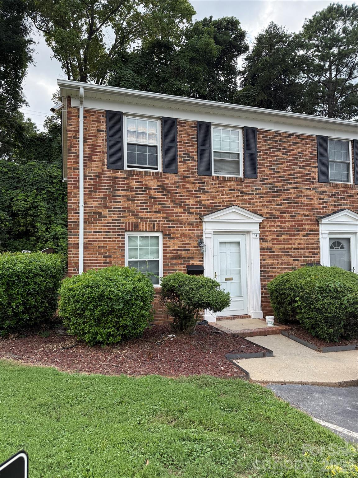 250 Nixon Road, Unit 19 Belmont, NC 28012 - Photo 2 of 27 a front view of a house with a yard and garage