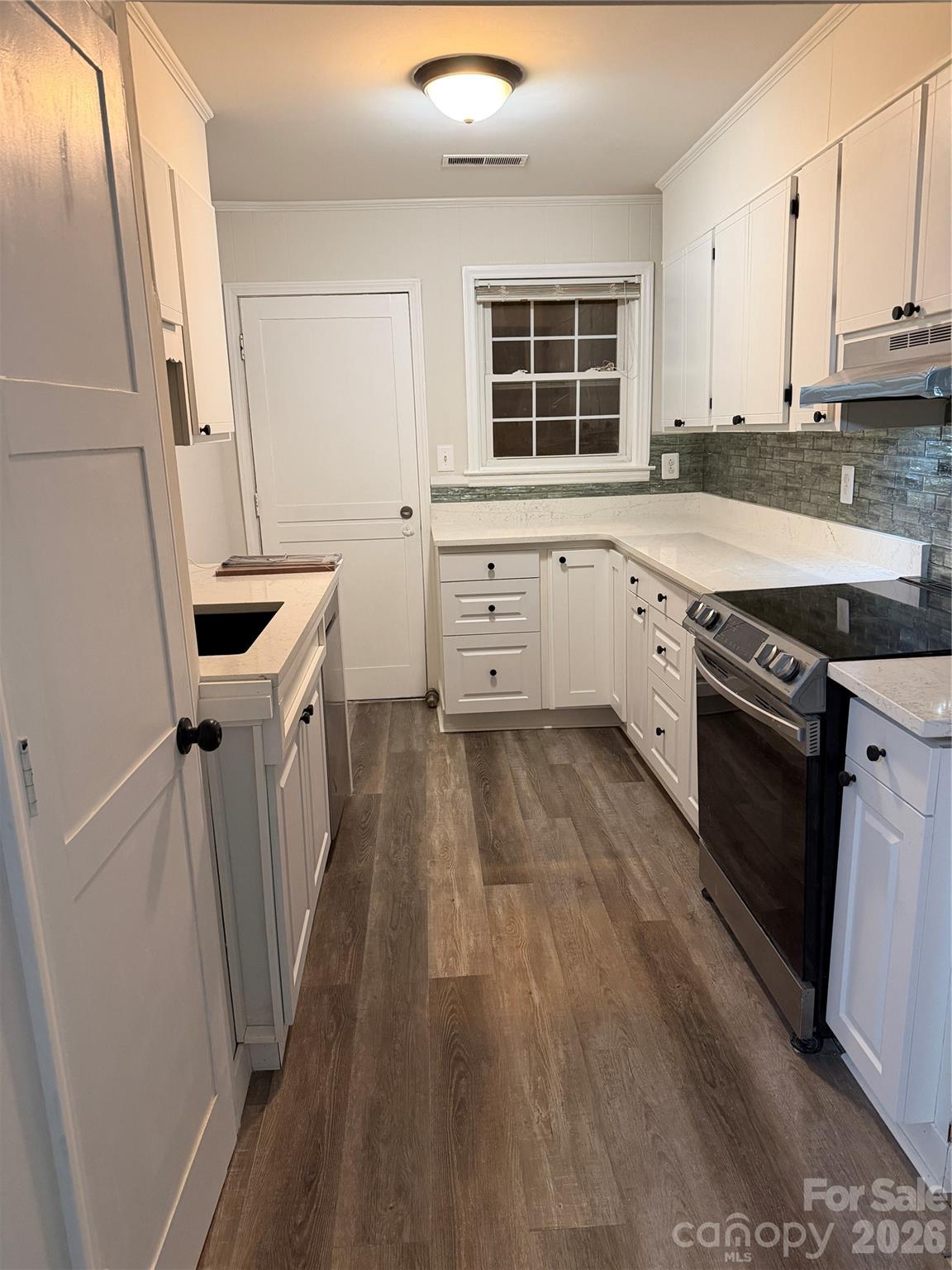 250 Nixon Road, Unit 19 Belmont, NC 28012 - Photo 21 of 27 a kitchen with wooden cabinets and a stove top oven