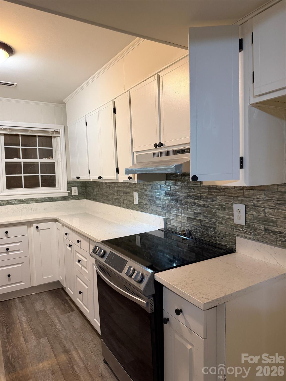 250 Nixon Road, Unit 19 Belmont, NC 28012 - Photo 23 of 27 a view of a kitchen with stainless steel appliances cabinets and a large window