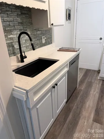 a white toilet sitting next to a white sink
