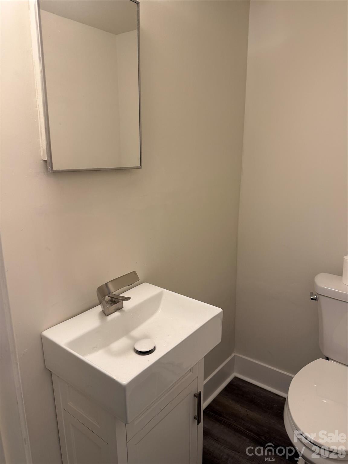 250 Nixon Road, Unit 19 Belmont, NC 28012 - Photo 26 of 27 a bathroom with a sink a toilet and mirror