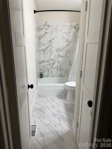 a bathroom with a shower and a toilet