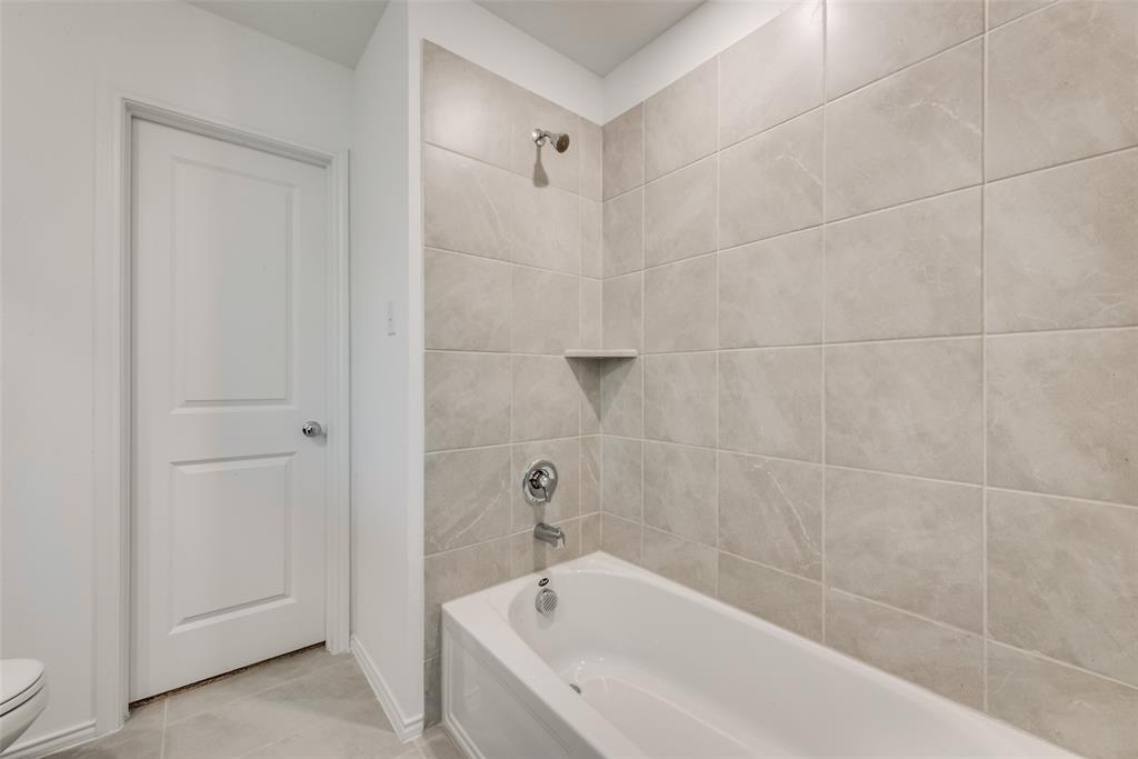 6112 Determine Lane Forney, TX 75126 - Photo 13 of 17 Bathroom with tub / shower combination and light tile patterned flooring