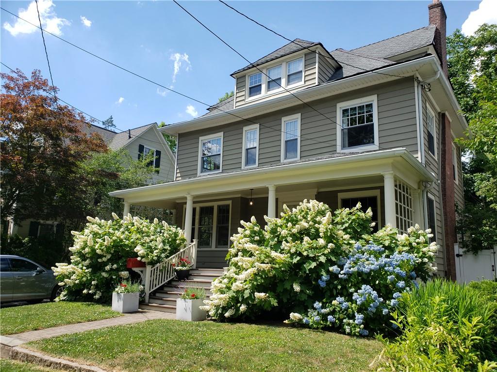 a front view of a house with a garden