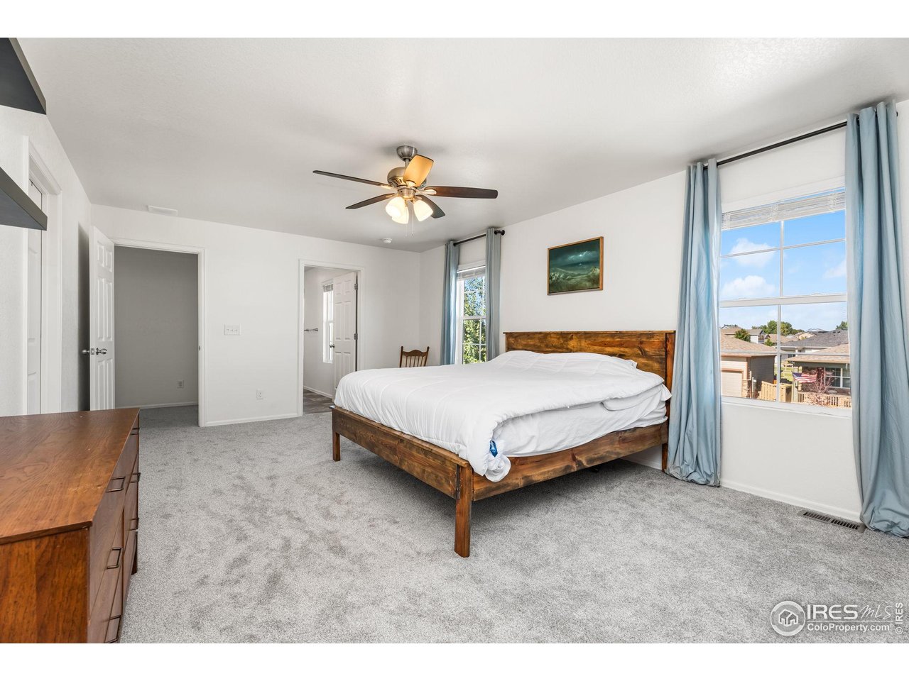503 Buckrake Street Severance, CO 80550 - Photo 23 of 40 a bedroom with a bed and a chandelier